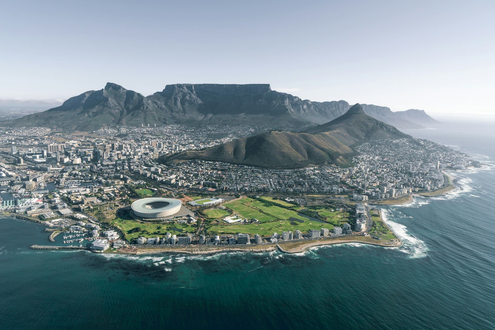 The Cape Town city bowl at sunrise, seen from Signal Hill, with the harbour on the left and the Hottentots-Holland mountains beyond.